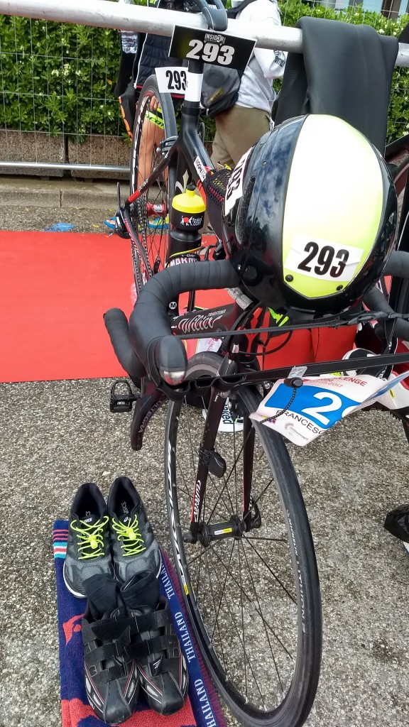 Placing the helmet on the handlebars makes it easier to remember. Races are strict about wearing and securing the helmet on your head when handling the bike in transition, if you forget you might get a time penalty!